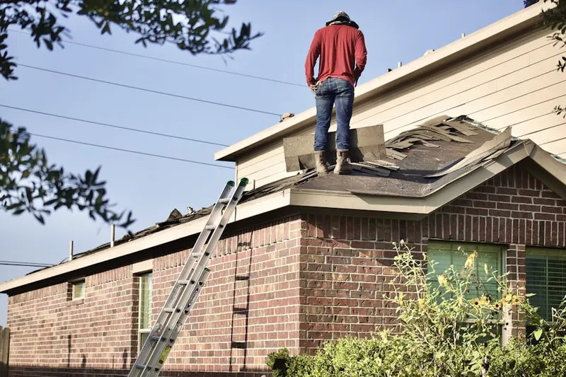 Professional roofer working on a residential roof in Baptistown